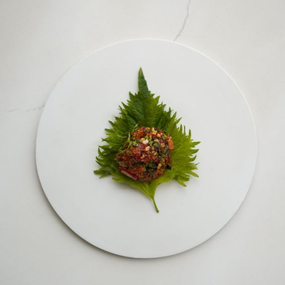Leaf with food on top of the plate.
