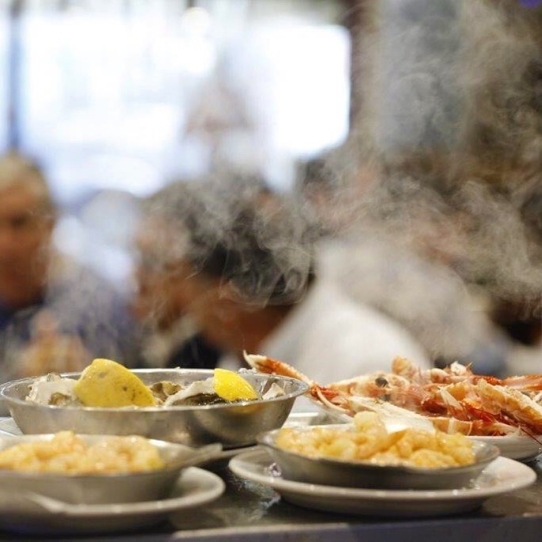 Steaming plates of seafood.