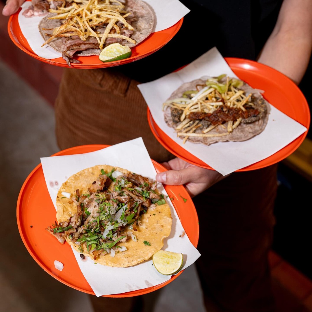 Three plates with tacos.